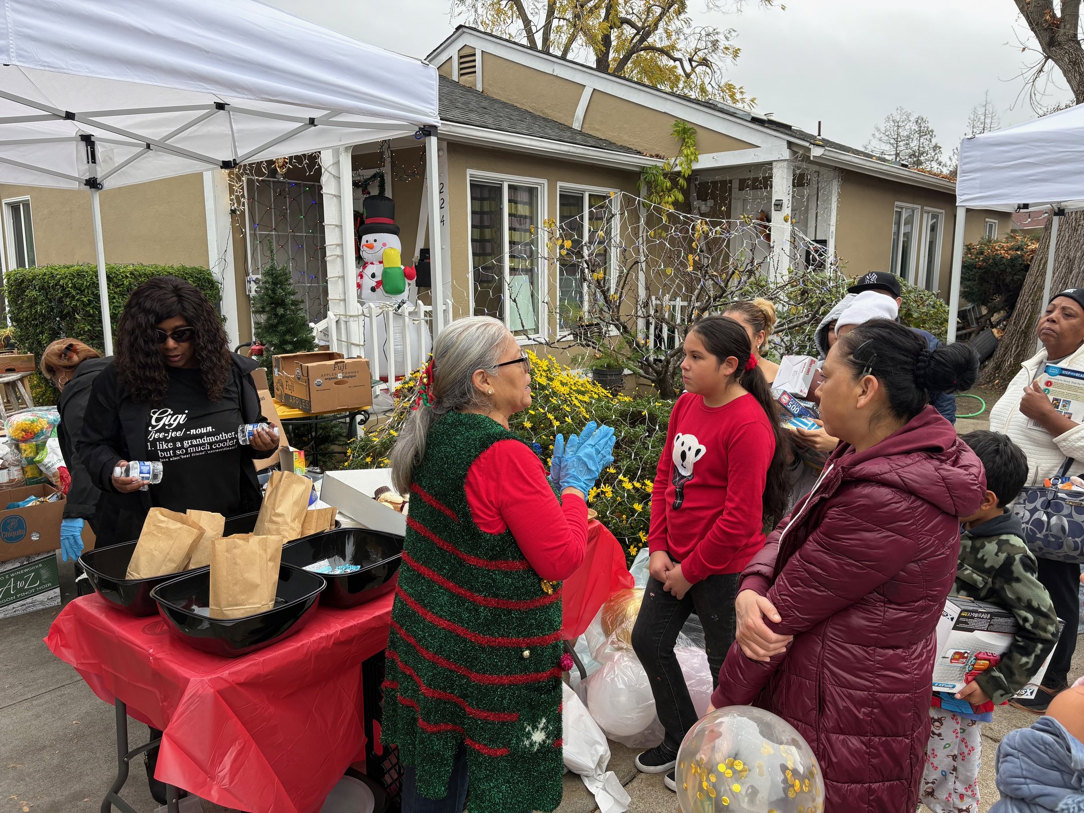Families and volunteers gathered around a distribution table